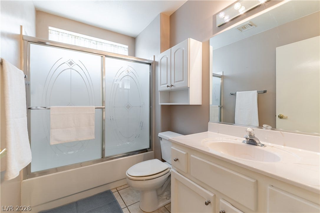 10005 Arbuckle Drive, Las Vegas, NV 89134 Smooth tile flooring and a neutral vanity define this comfortable bathroom space.