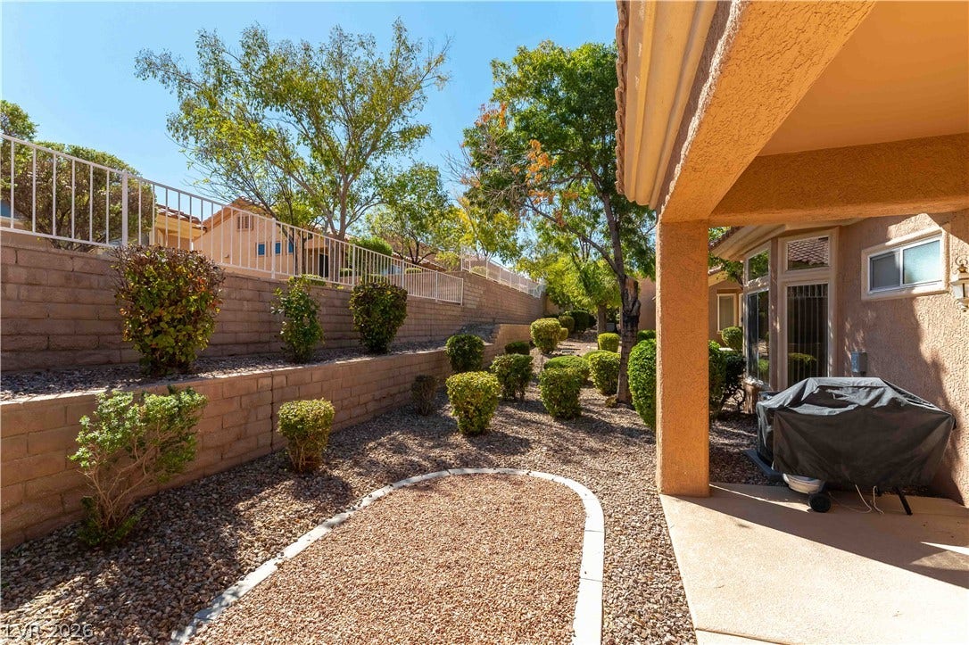 10005 Arbuckle Drive, Las Vegas, NV 89134 Tiered block retaining walls create structural depth across a low-maintenance gravel yard.