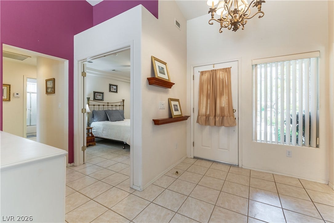10005 Arbuckle Drive, Las Vegas, NV 89134 A welcoming entryway features tile flooring, soaring vaulted ceilings, and a classic chandelier fixture.