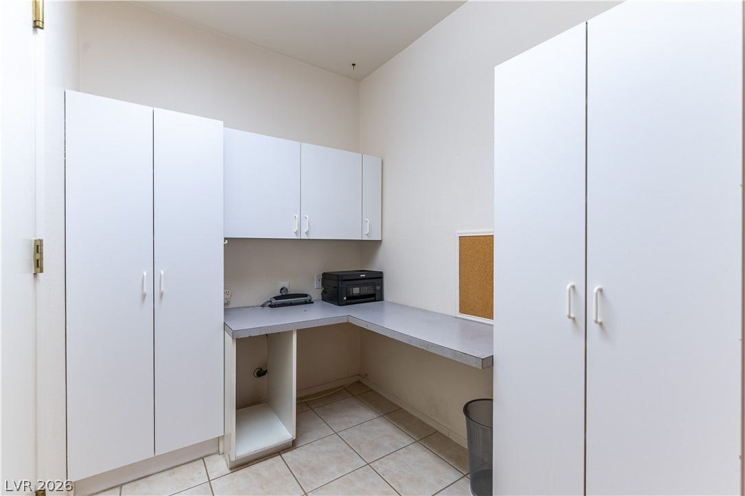 10005 Arbuckle Drive, Las Vegas, NV 89134 Ample built-in cabinetry and expansive workspace define this functional utility area.