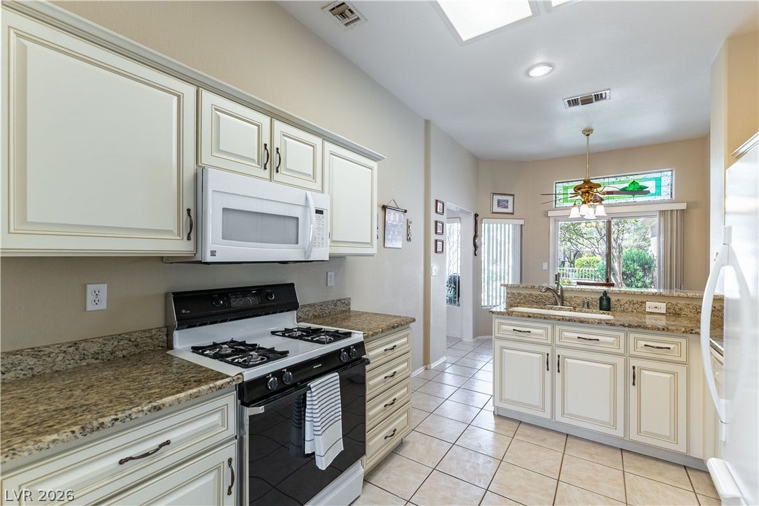 10005 Arbuckle Drive, Las Vegas, NV 89134 Polished granite countertops complement classic cabinetry under a soaring skylight.