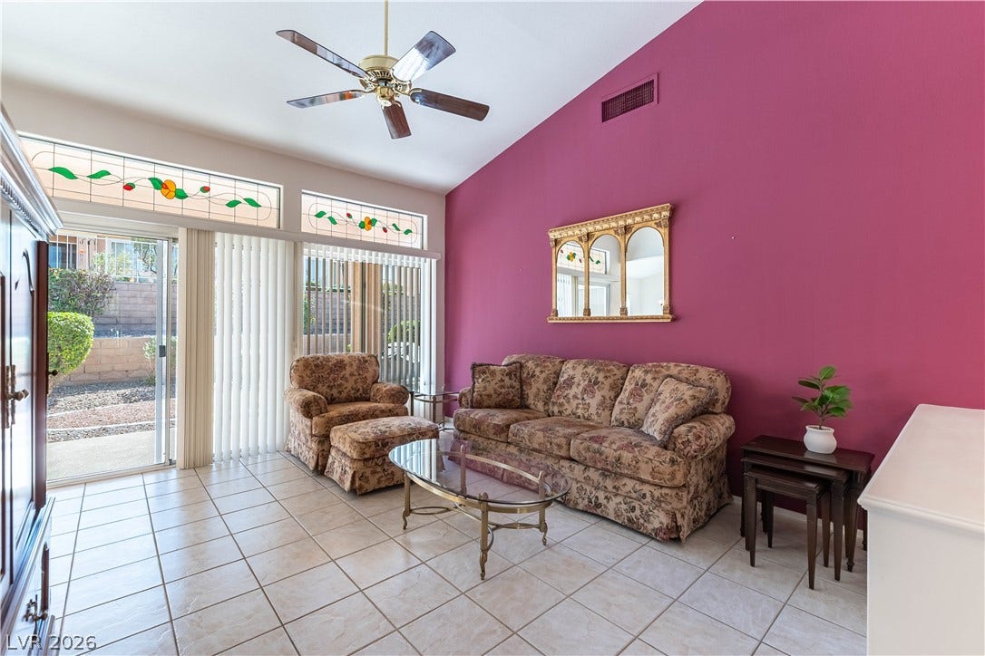 10005 Arbuckle Drive, Las Vegas, NV 89134 Soaring vaulted ceilings and sliding glass doors enhance this tiled living area.