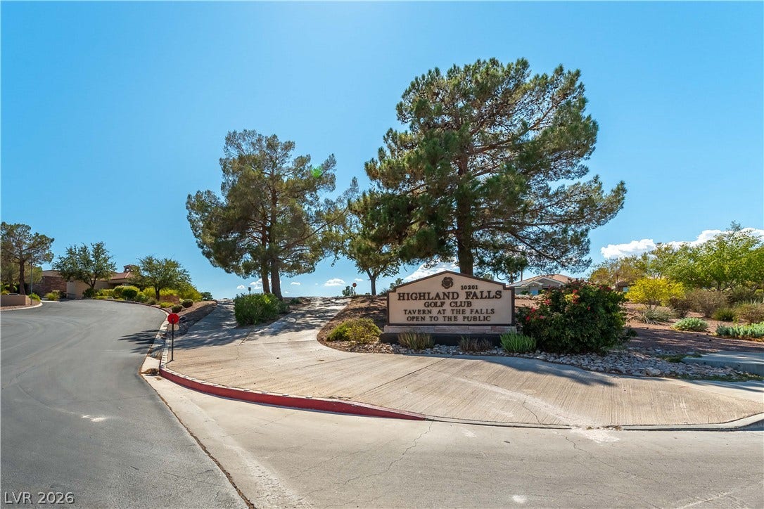 10005 Arbuckle Drive, Las Vegas, NV 89134 Mature trees and professional landscaping flank the welcoming neighborhood entrance sign under clear blue skies.