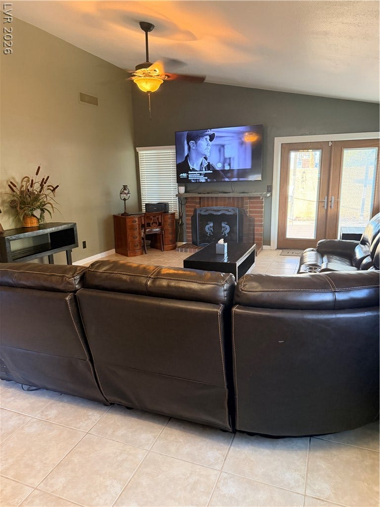 3126 Belvedere Drive, Henderson, NV 89014 Tiled flooring and a brick fireplace insert establish character in this comfortable living area.