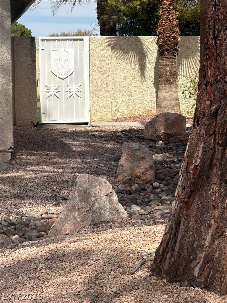 3126 Belvedere Drive, Henderson, NV 89014 Low-maintenance desert landscaping leads to a secure gated entryway.