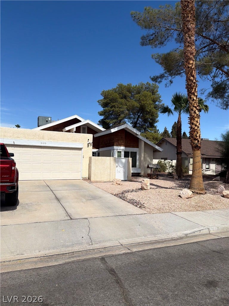 3126 Belvedere Drive, Henderson, NV 89014 Palm trees accent the low-maintenance desert landscaping leading up to this multi-textured facade.
