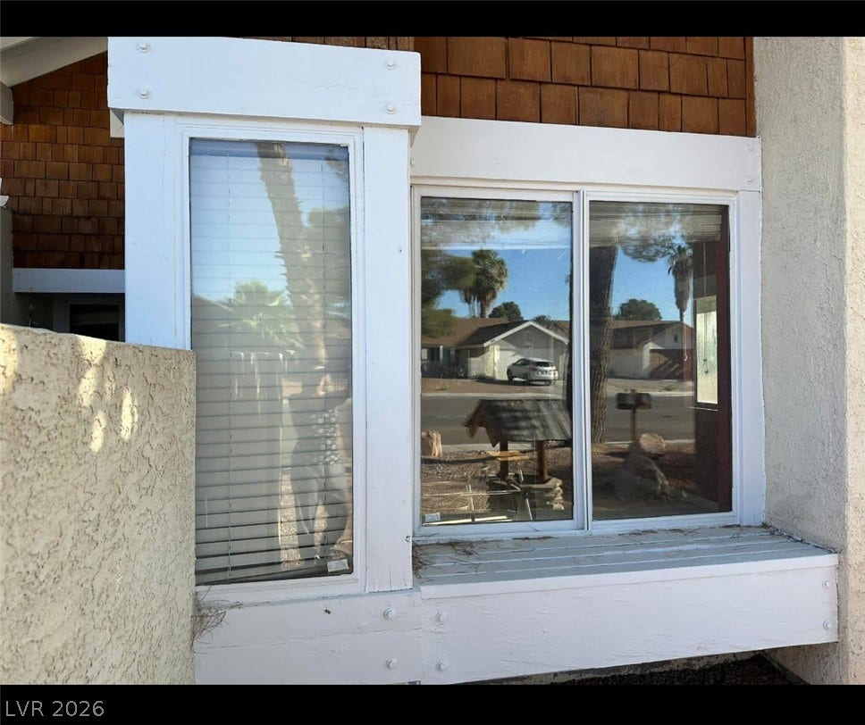 3126 Belvedere Drive, Henderson, NV 89014 Bold architectural trim frames large windows set against classic shingle siding.