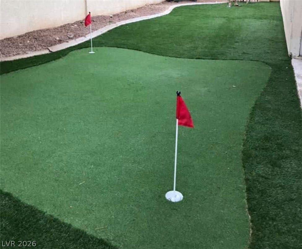 3126 Belvedere Drive, Henderson, NV 89014 A private putting green offers outdoor recreation within the fenced backyard.