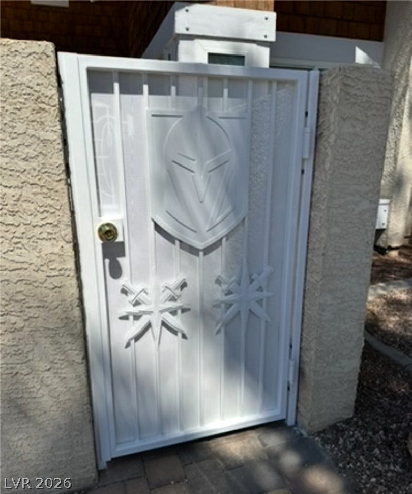 3126 Belvedere Drive, Henderson, NV 89014 An custom ornamental metal gate provides secure, private entry to the property.