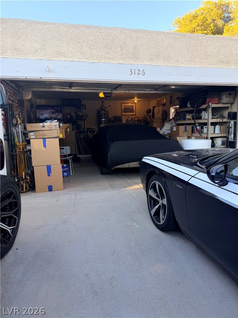 3126 Belvedere Drive, Henderson, NV 89014 Concrete driveway leads directly into a spacious garage with a stucco exterior finish.
