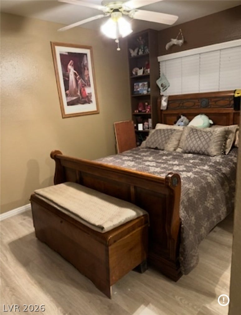 3126 Belvedere Drive, Henderson, NV 89014 Smooth wood-look flooring and integrated shelving maximize the utility of this cozy bedroom.