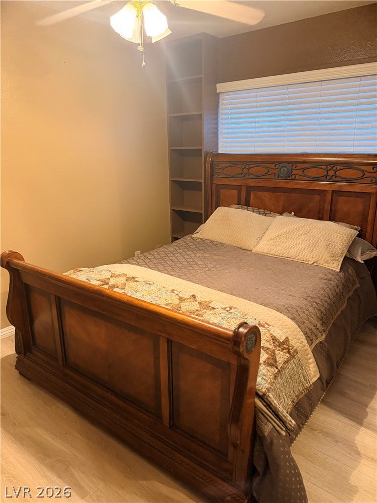 3126 Belvedere Drive, Henderson, NV 89014 Smooth wood floors anchor this cozy room featuring a tall built-in bookcase next to the window.