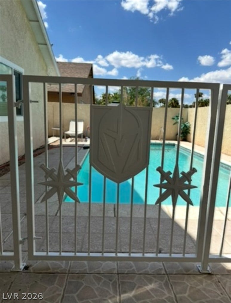 3126 Belvedere Drive, Henderson, NV 89014 A secure safety fence frames the refreshing in-ground pool under bright desert skies.