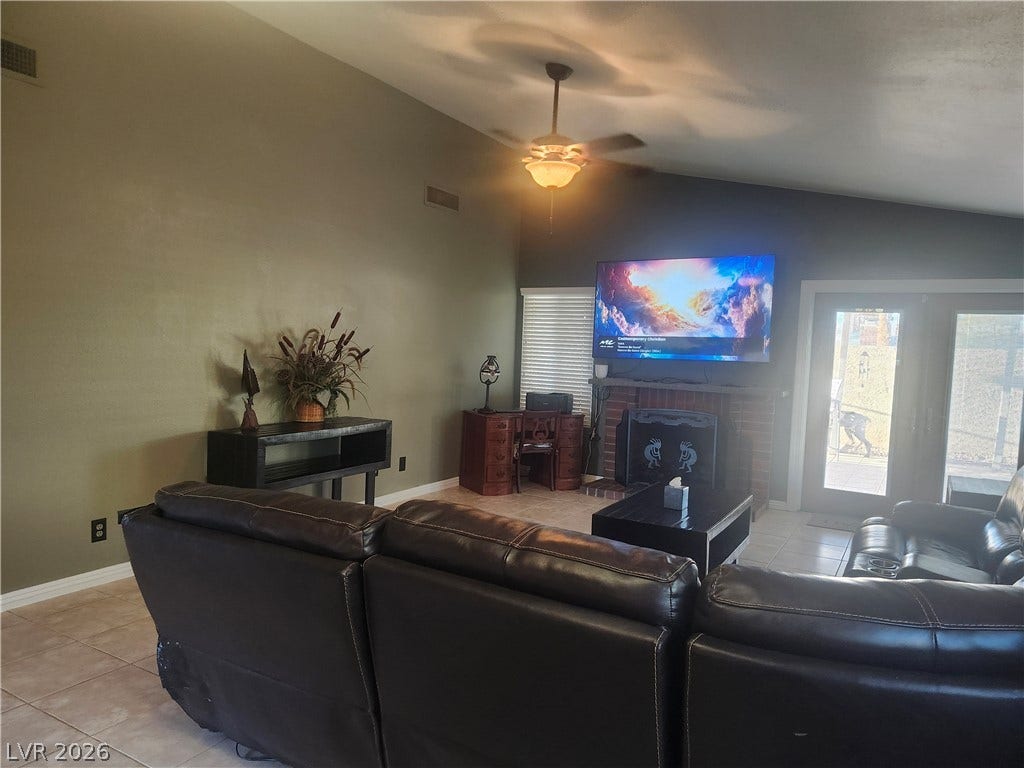 3126 Belvedere Drive, Henderson, NV 89014 Soaring vaulted ceilings and a brick fireplace highlight this welcoming living space.