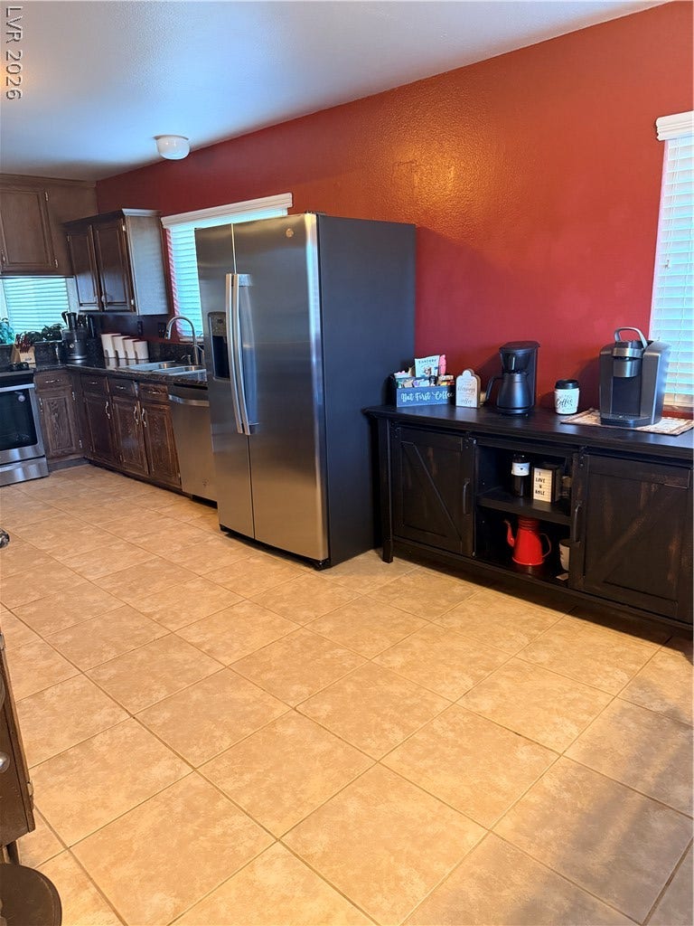 3126 Belvedere Drive, Henderson, NV 89014 Durable tile flooring pairs with classic wood cabinetry in this functional cooking space.