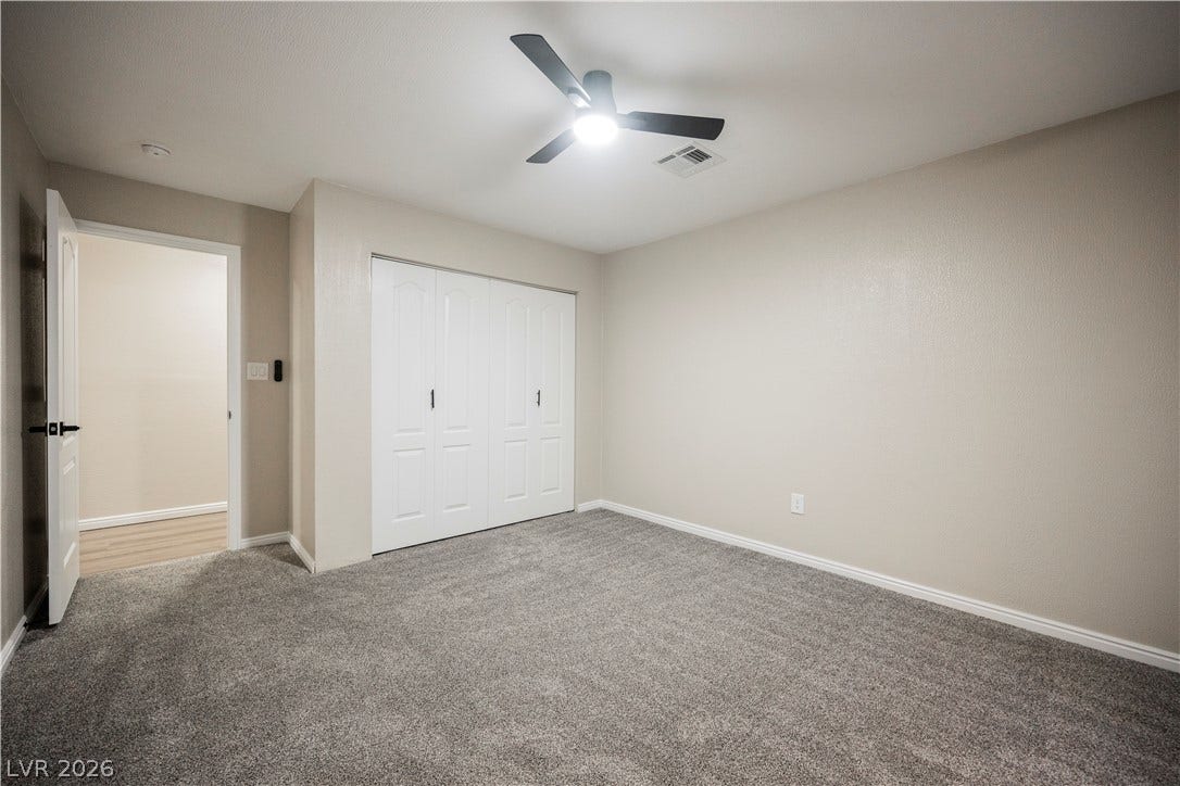 601 Sandy Drive, Henderson, NV 89002 Plush carpeting anchors this quiet bedroom space featuring a generous closet.