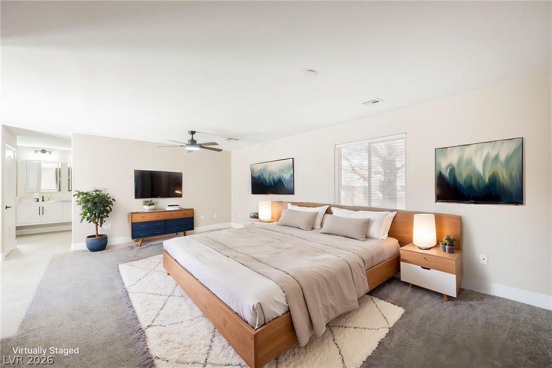 601 Sandy Drive, Henderson, NV 89002 A spacious bedroom offers plush carpeting and a large window looking out to the yard.