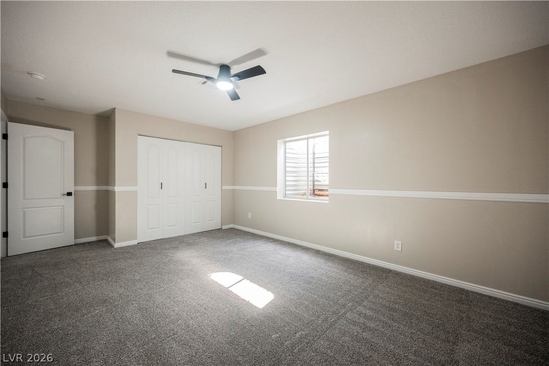601 Sandy Drive, Henderson, NV 89002 Classic chair rail molding and plush carpeting define this versatile living space.