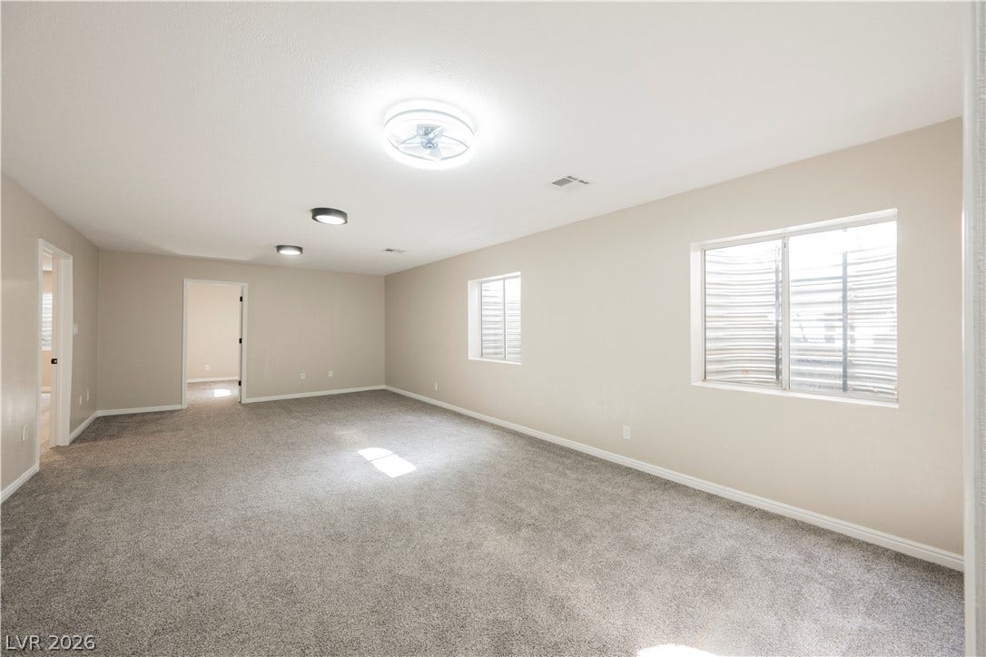 601 Sandy Drive, Henderson, NV 89002 Plush wall-to-wall carpeting and soft natural light define this versatile, open living area.