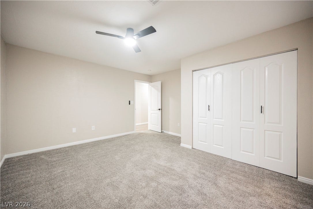 601 Sandy Drive, Henderson, NV 89002 Plush carpeting and crisp white doors highlight this functional bedroom space.