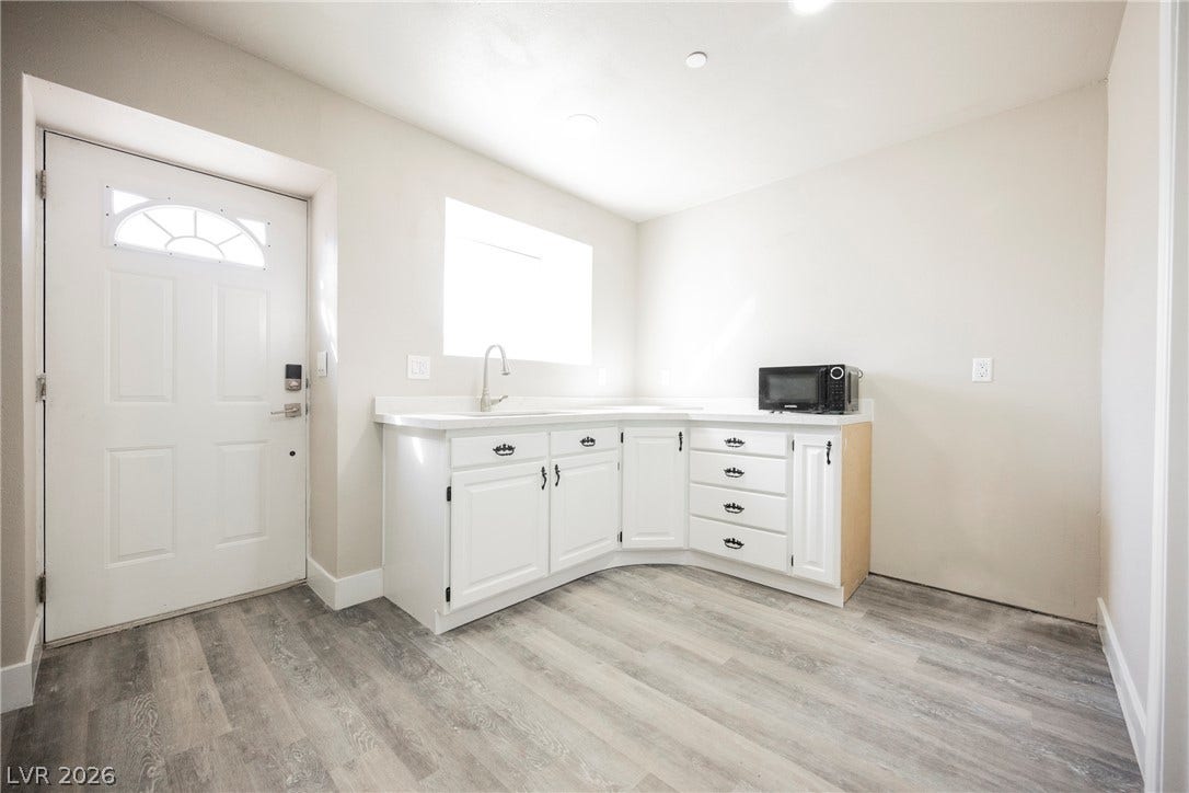 601 Sandy Drive, Henderson, NV 89002 Smooth wood-look flooring and clean white cabinetry anchor this functional entry space.