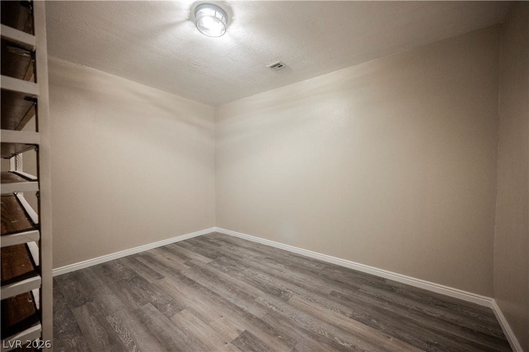601 Sandy Drive, Henderson, NV 89002 Modern wood-look flooring and built-in shelving define this versatile, windowless storage space.
