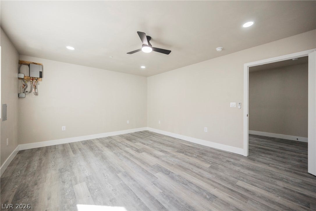 601 Sandy Drive, Henderson, NV 89002 Smooth plaster walls and durable vinyl plank flooring frame this versatile open basement space.