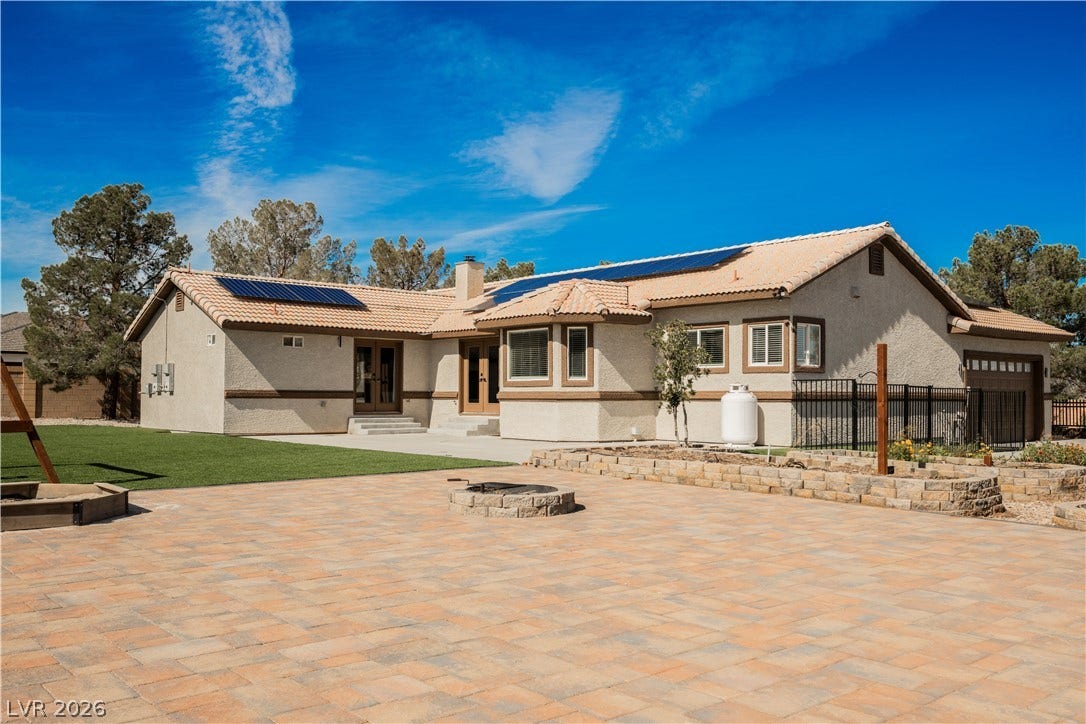 601 Sandy Drive, Henderson, NV 89002 An expansive paver patio surrounds a stone fire pit in the sprawling backyard.