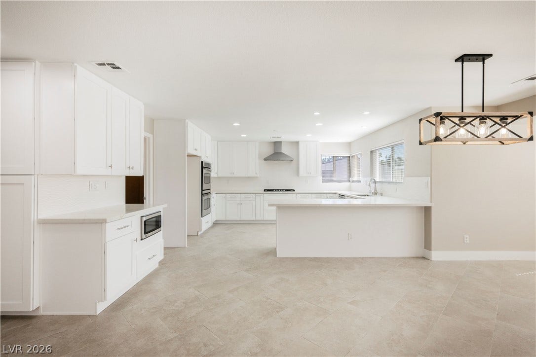 601 Sandy Drive, Henderson, NV 89002 Clean lines and durable tile flooring define this spacious, light-filled kitchen space.