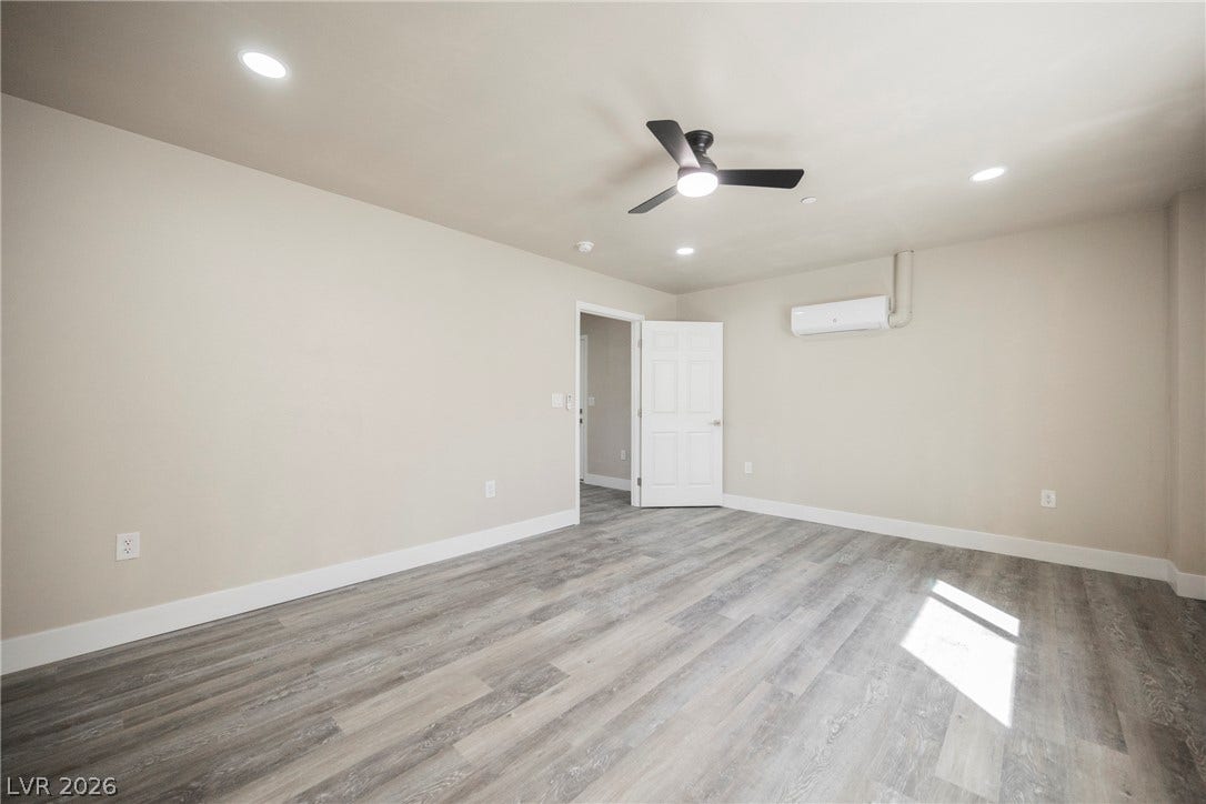 601 Sandy Drive, Henderson, NV 89002 Smooth plaster walls and wood-look flooring establish a minimalist foundation in this versatile interior space.