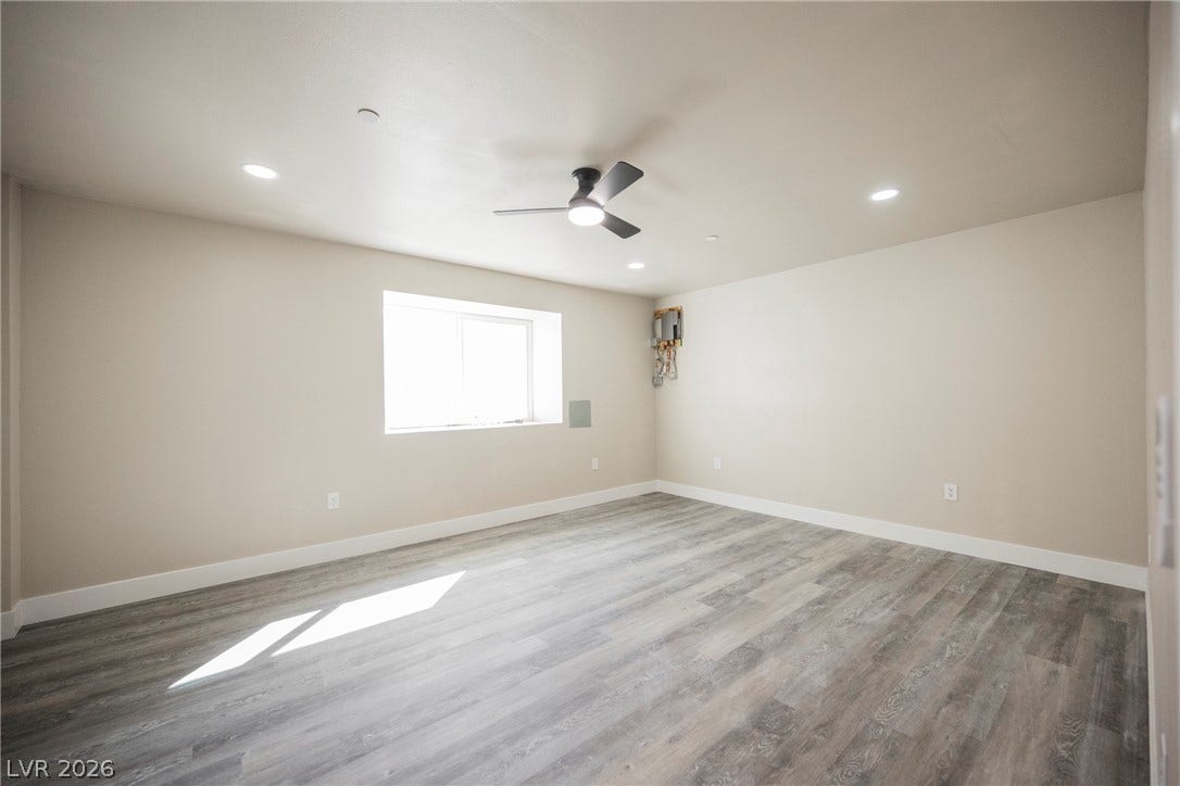 601 Sandy Drive, Henderson, NV 89002 Smooth plaster walls and wood-look flooring establish a clean foundation in this versatile basement space.