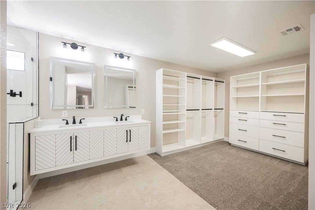 601 Sandy Drive, Henderson, NV 89002 A spacious walk-in closet connects seamlessly to a double vanity and a glass shower.