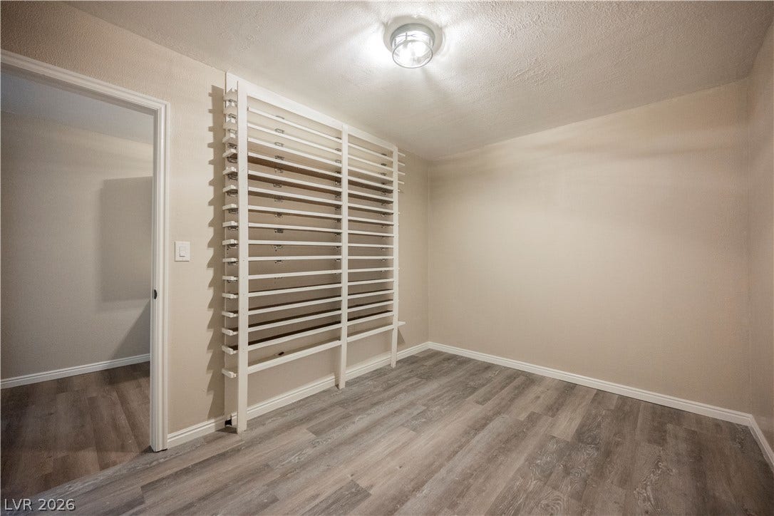 601 Sandy Drive, Henderson, NV 89002 A versatile extra room showcases durable plank flooring alongside a custom built-in rack.