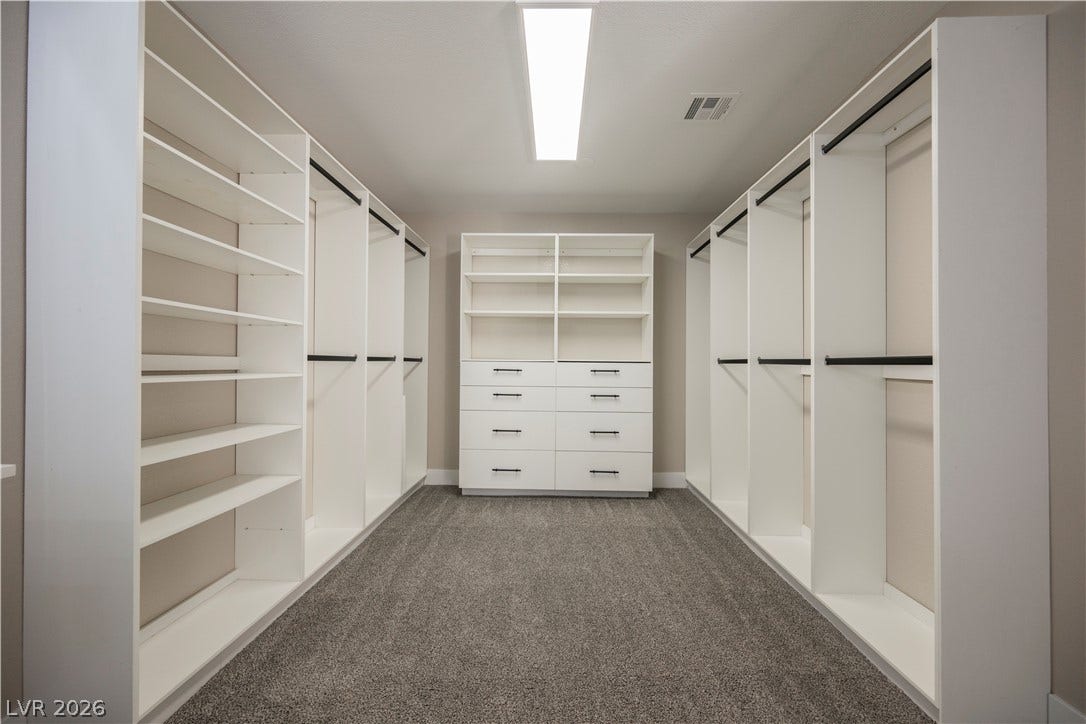 601 Sandy Drive, Henderson, NV 89002 Custom built-in shelving and soft carpeting define this spacious closet design.