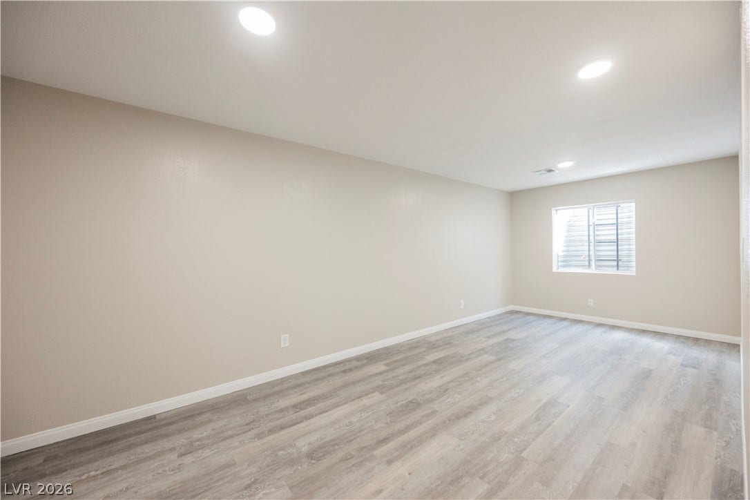 601 Sandy Drive, Henderson, NV 89002 Smooth wood-look flooring and clean neutral walls define this versatile lower-level living space.