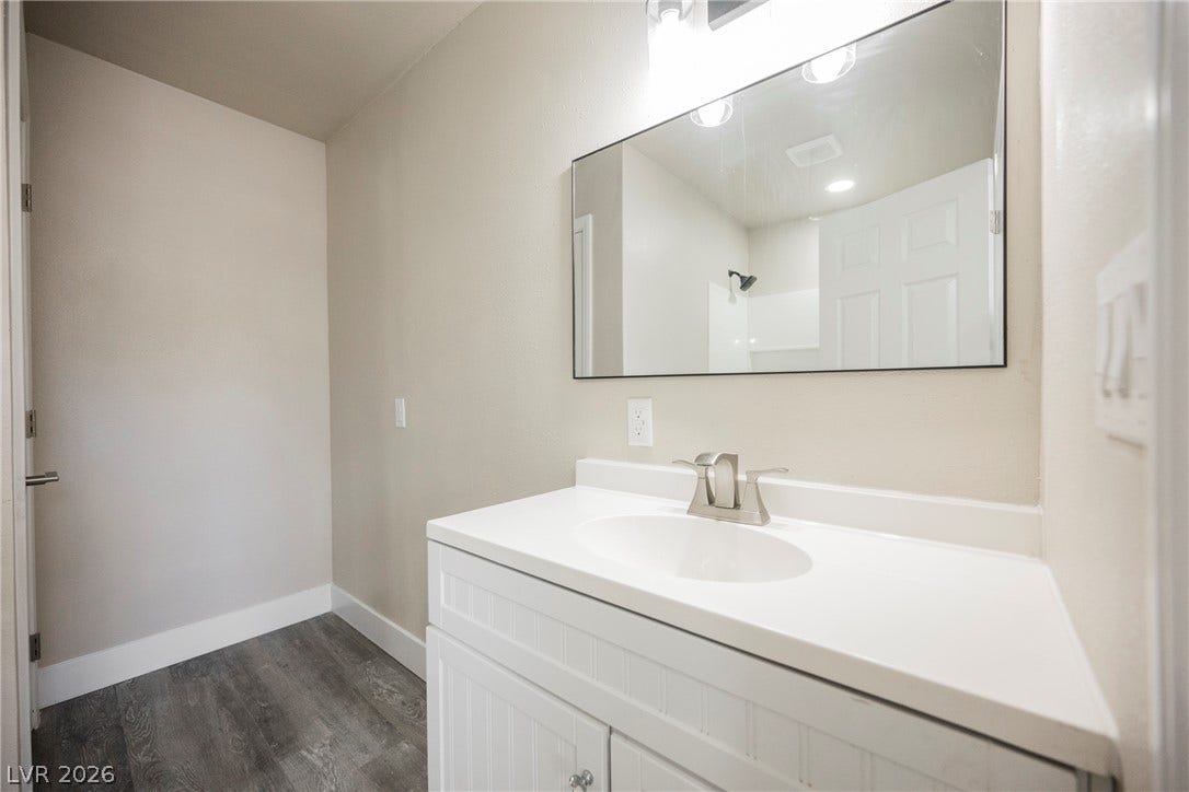 601 Sandy Drive, Henderson, NV 89002 A modern vanity with a large mirror sits on durable wood-look flooring.