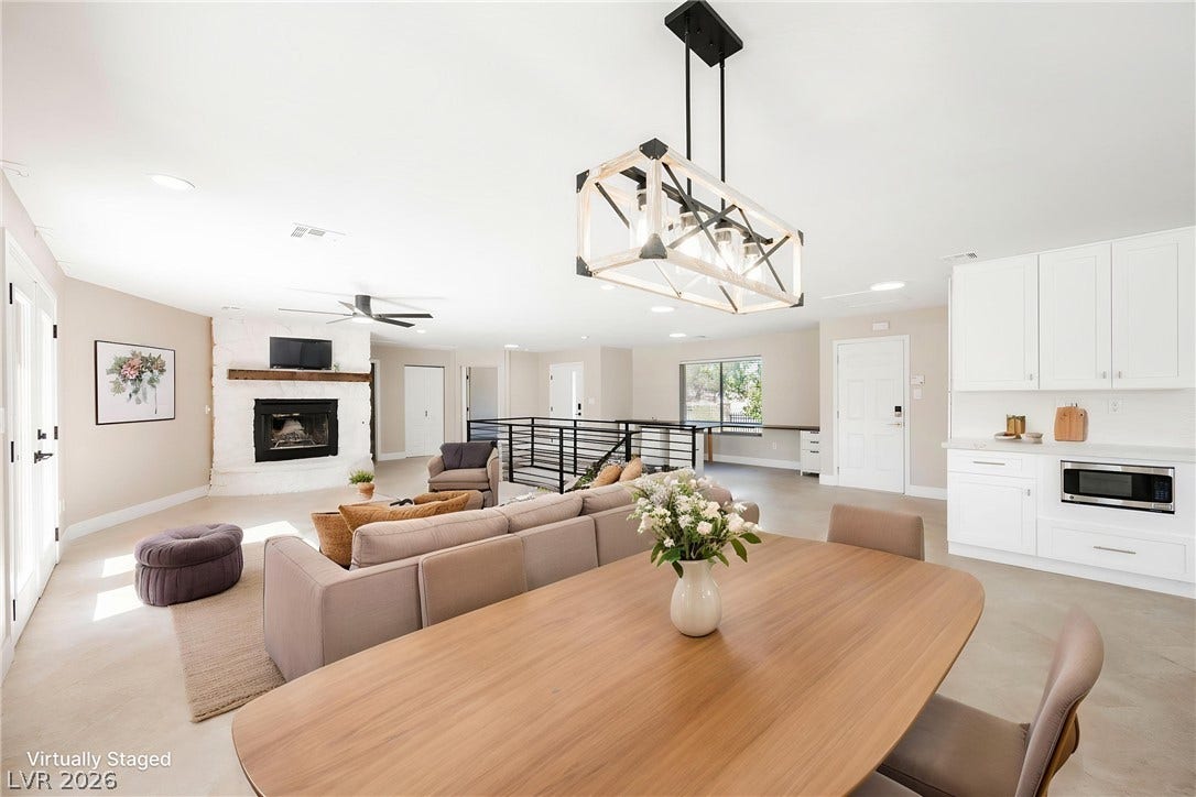 601 Sandy Drive, Henderson, NV 89002 Clean lines and a fireplace define this light-filled, open-concept living area with smooth flooring.