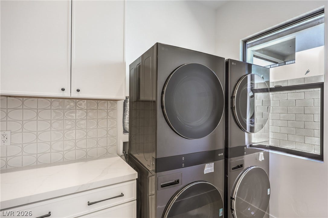 3051 E Serene Avenue, Henderson, NV 89074 A functional laundry space featuring stone countertops, integrated cabinetry, and abundant natural light.