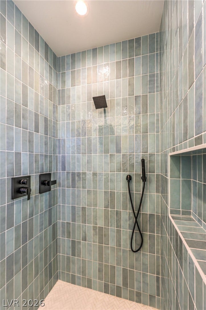 3051 E Serene Avenue, Henderson, NV 89074 Glazed vertical tiles and modern matte black fixtures create a spa-like shower experience.