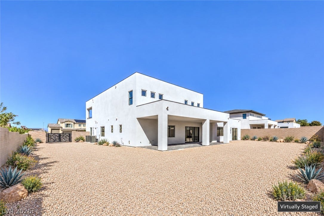 3051 E Serene Avenue, Henderson, NV 89074 Minimalist modern lines define this stucco exterior featuring a covered patio and xeriscaped yard.