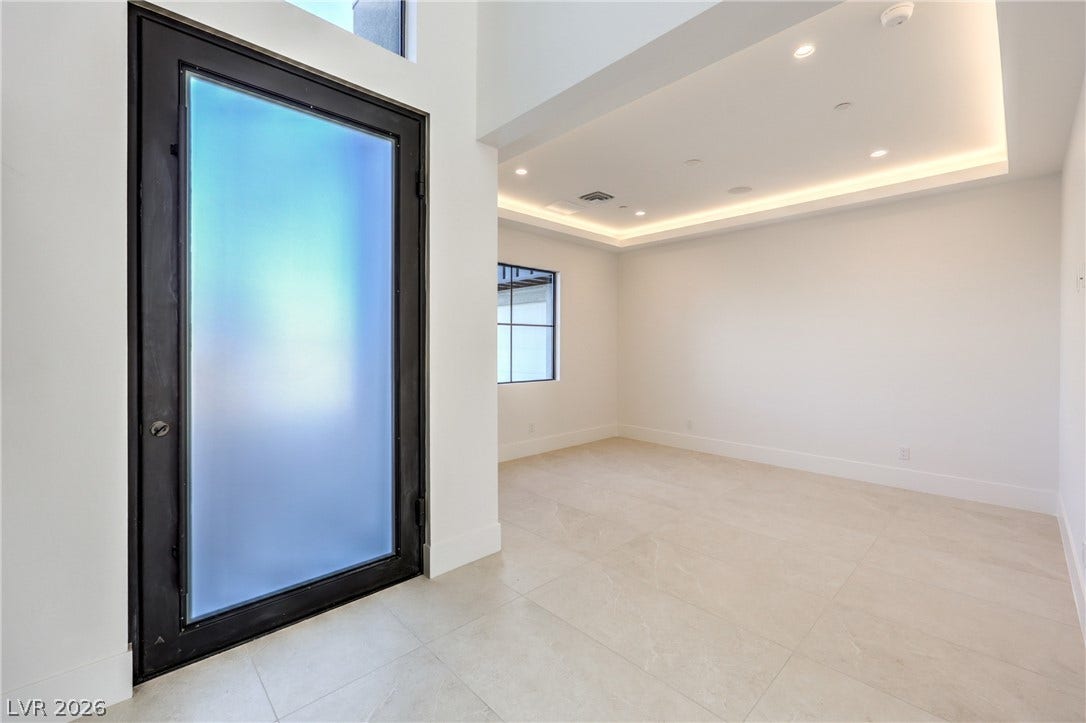 3051 E Serene Avenue, Henderson, NV 89074 An inviting entryway transitions smoothly into a bright room featuring modern recessed tray ceiling lighting.