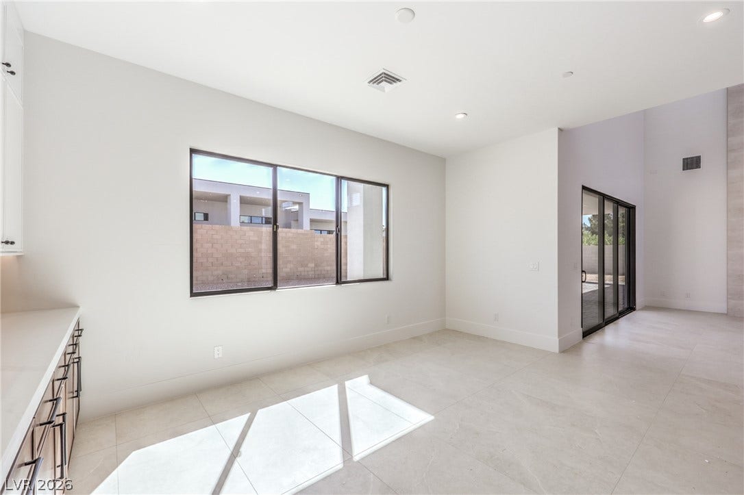 3051 E Serene Avenue, Henderson, NV 89074 Large windows and sleek tile floors define this airy, open interior space.