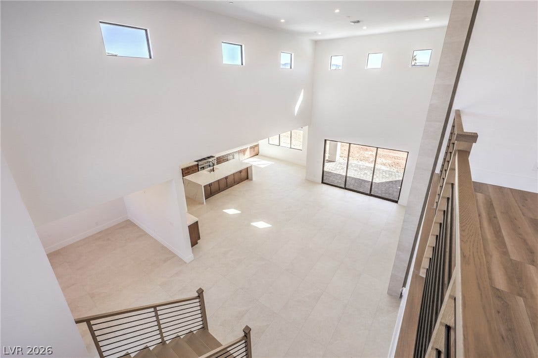 3051 E Serene Avenue, Henderson, NV 89074 Dramatic high ceilings and a wall of windows define this light-filled, open-concept living area.