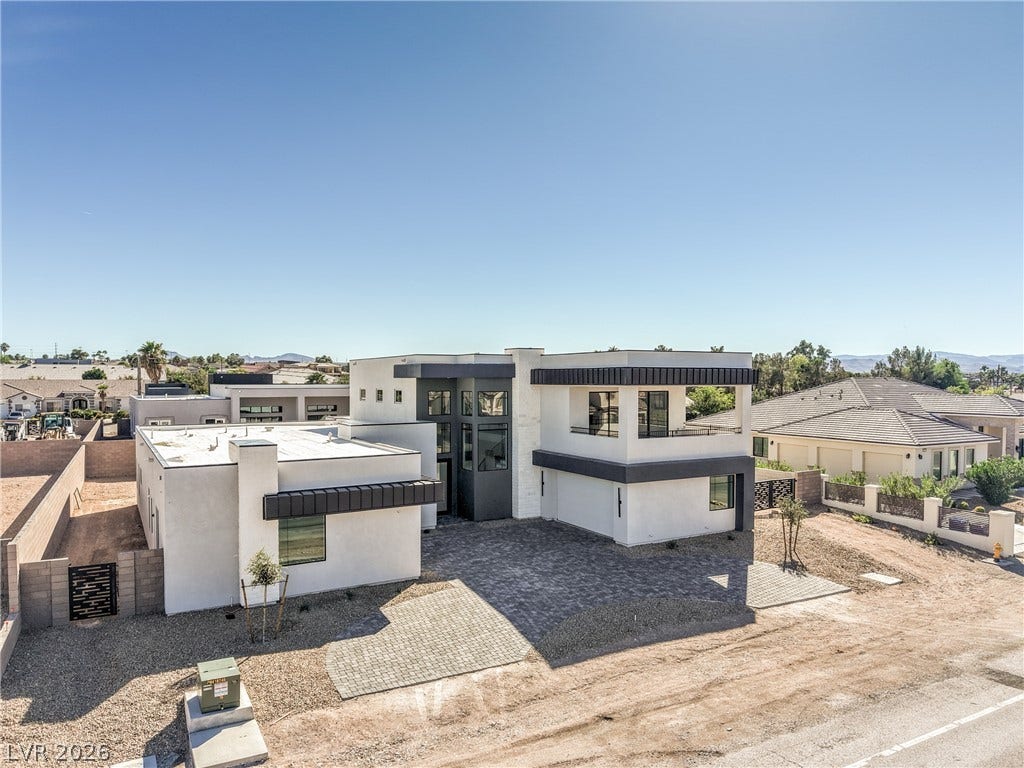 3051 E Serene Avenue, Henderson, NV 89074 Striking contemporary architecture defines this multi-level home featuring clean lines and a paved driveway.