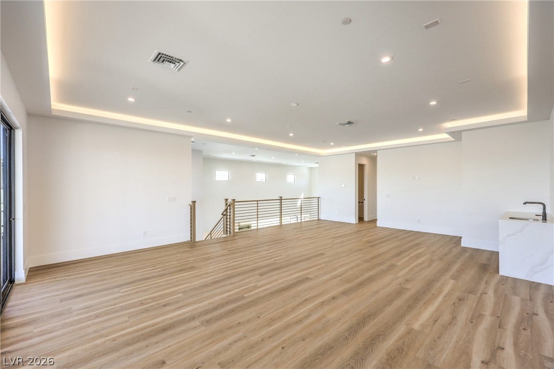 3051 E Serene Avenue, Henderson, NV 89074 Warm wood flooring meets modern recessed cove lighting across this airy second-level loft space.