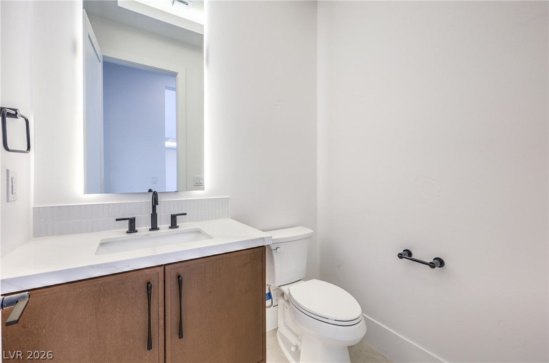 3051 E Serene Avenue, Henderson, NV 89074 Clean lines and a floating-style mirror define this modern powder room.