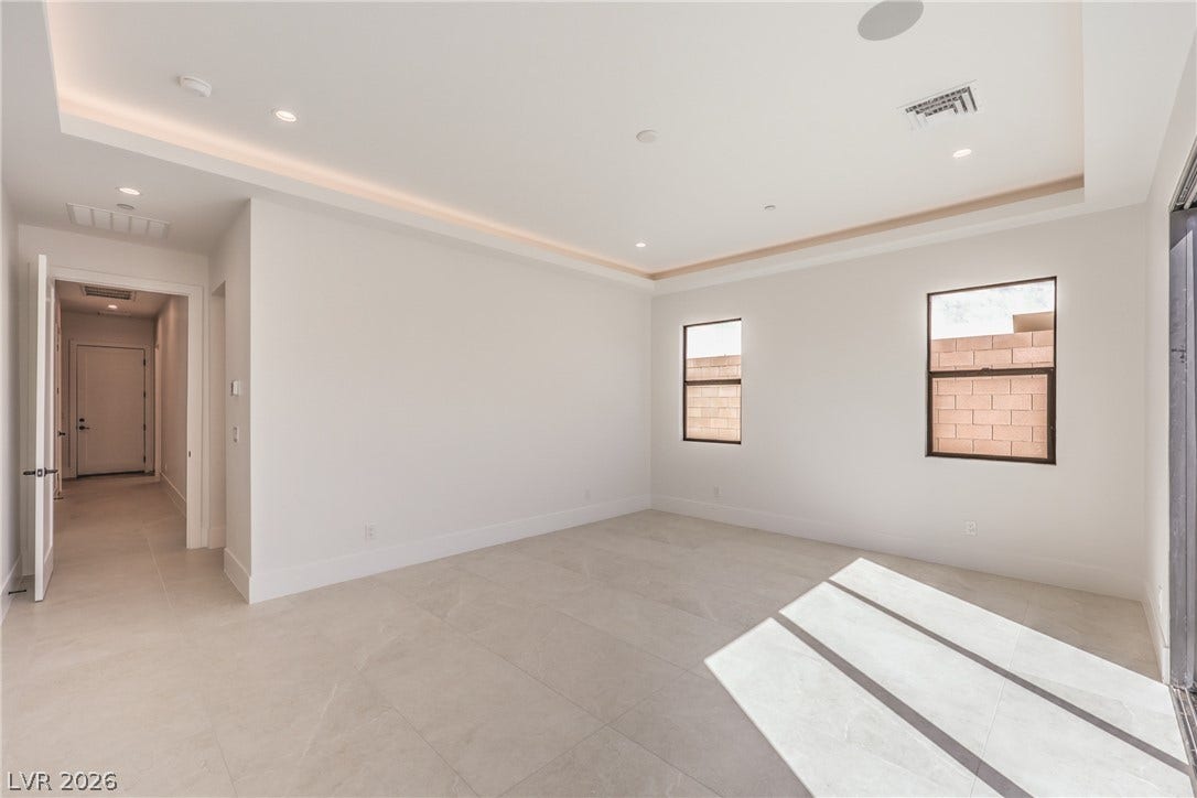 3051 E Serene Avenue, Henderson, NV 89074 Gleaming tile floors and a recessed tray ceiling define this versatile, sunlit interior space.