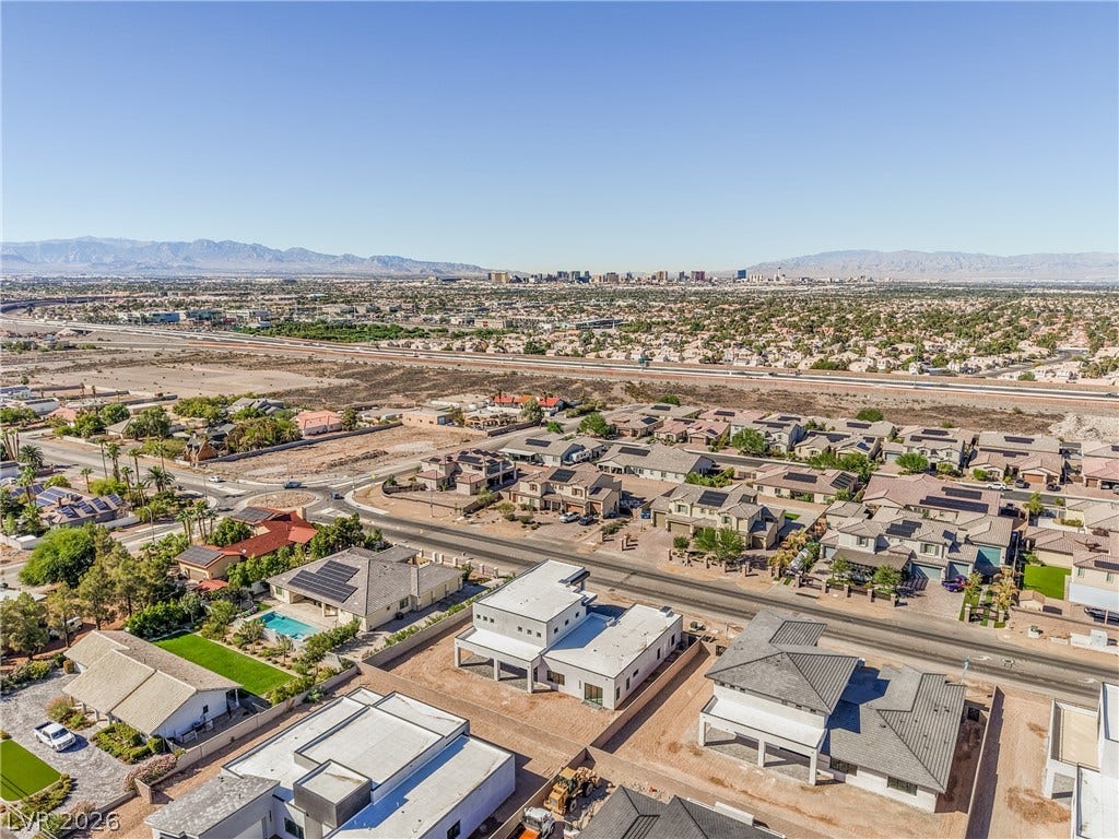3051 E Serene Avenue, Henderson, NV 89074 An aerial perspective captures the neighborhood and distant skyline views under a clear sky.