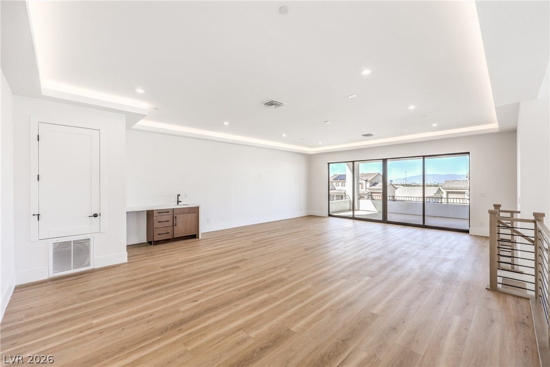 3051 E Serene Avenue, Henderson, NV 89074 Smooth wood floors and recessed lighting enhance this airy space, complete with a wet bar.