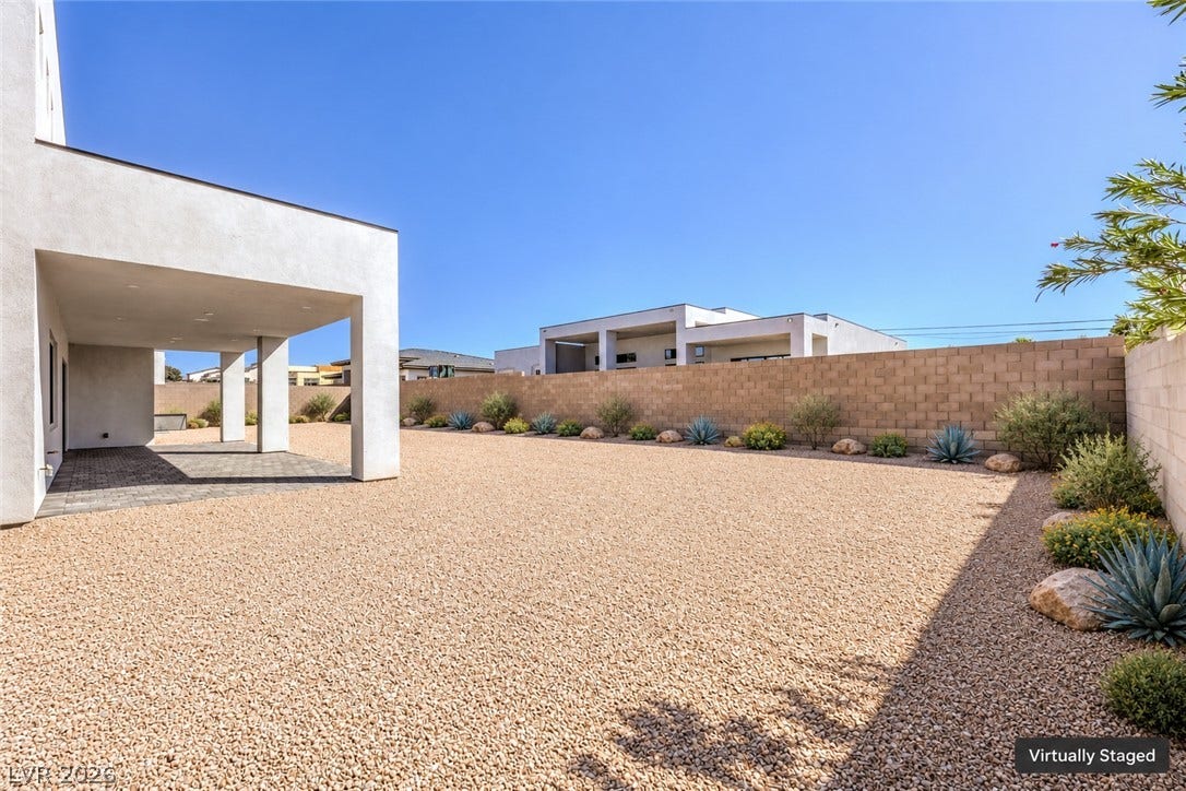 3051 E Serene Avenue, Henderson, NV 89074 Minimalist desert landscaping surrounds a modern covered patio beneath clear blue skies.